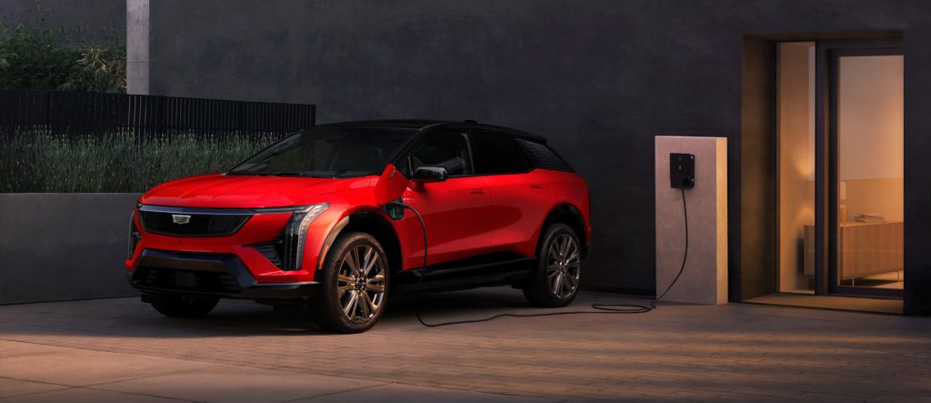 Image of a red 2025 Cadillac OPTIQ charging at a charging station.